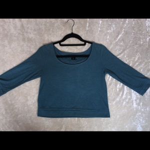 Blue crop top, cropped sleeves.